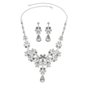 Detailed view of silver bridal jewelry set with pearl and rhinestone floral design