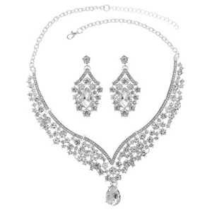 Macro detail of silver V-shaped necklace and drop earrings with pear-cut rhinestones