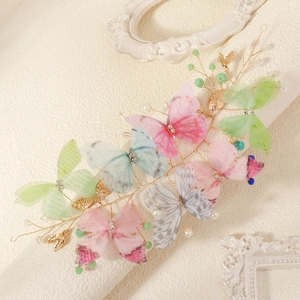 Detailed close-up of butterfly hair clips with gradient tulle and pearl embellishments