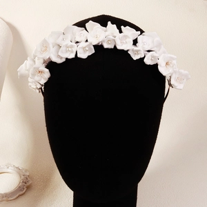 Detailed view of handmade white floral bridal headband with delicate pearl centers