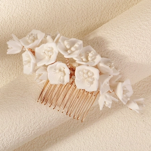 Elegant white floral hair comb with pearls and golden metal teeth for bridal styling