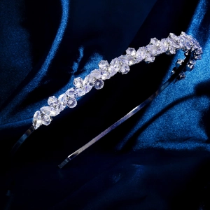Close-up of elegant silver headband featuring marquise cut zircon leaves on silk fabric