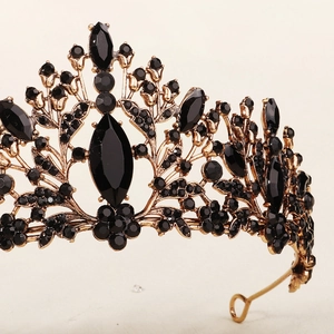 Close-up of gothic crown with black gemstones and vintage gold floral metal details