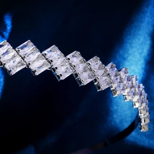 Detail of luxury zircon headband with rectangular crystals on blue silk background
