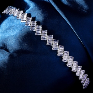 Macro shot of silver zircon headband with geometric crystal rows on blue satin