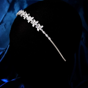 Détail d'un serre-tête floral en zircon argenté sur un support en velours noir