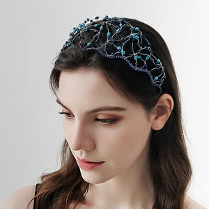 Detail of handcrafted blue crystal mesh headband with intricate beadwork and crown design