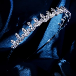 Detailed view of silver zircon headband crown with marquise-cut stones on blue silk