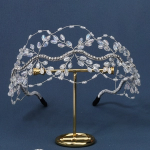 Detailed view of bridal headband with crystal beads and rhinestones on display stand