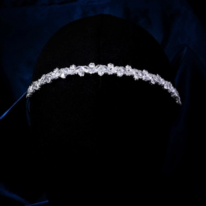Detailed close-up of wavy silver headband with sparkling marquise rhinestones and zircons