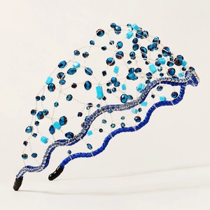 Detailed view of handwoven blue crystal beads on silver wire mesh headband