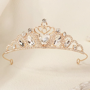 Close-up of golden crystal heart crown with sparkling rhinestones for parties