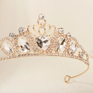 Close-up of golden heart crown headband with sparkling crystal rhinestones for weddings