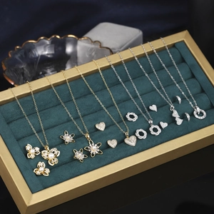 Detail view of vintage gold-plated necklaces and earrings with cubic zirconia and pearls