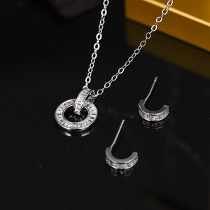 Macro shot of silver dual-loop pendant and matching earrings with micro-inlaid zircon stones
