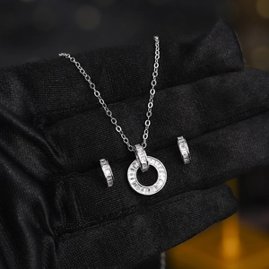 Close-up of sparkling zircon jewelry set with necklace and earrings held in hand