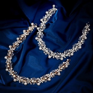 Detailed view of hand-woven bridal headband set with pearls and rhinestones on blue silk