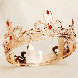 Detailed close-up of golden baroque crown with red crystals and fleur-de-lis pattern