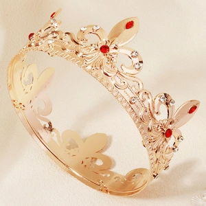 Detail of baroque crown showing gold hollow patterns and red marquise-cut rhinestones