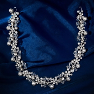 Detail view of handmade bridal headband with silver leaves, pearls and rhinestones