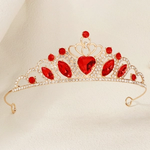Detailed macro view of a golden crown headpiece with sparkling red heart-shaped rhinestones