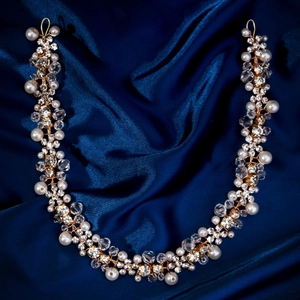 Detail of bridal hair vine with hand-woven gold wire pearls and crystal leaves