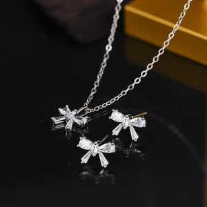 Detail of vintage micro-set zircon bow pendant necklace and matching stud earrings set