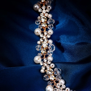 Detail of handmade bridal hair vine with white pearls and crystals on gold wire