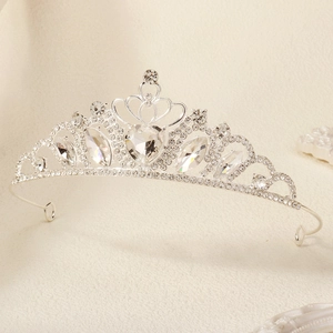 Close-up of silver tiara with heart-shaped crystal and rhinestones for weddings