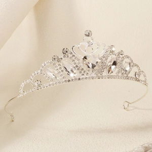 Close-up of silver princess crown with heart rhinestones and elegant swirl details