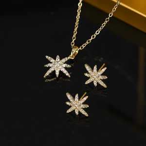 Detail view of gold 18K plated vintage jewelry set with micro-pave star pendants
