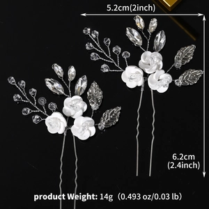 Detailed view of handmade flower hair pins with white resin petals and clear crystals