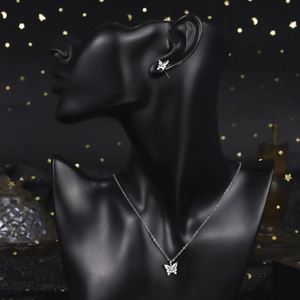 Detailed view of silver butterfly necklace and earring set with shimmering micro zircons