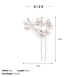Detail view of handmade silver bridal hair pin with white flowers and clear crystals