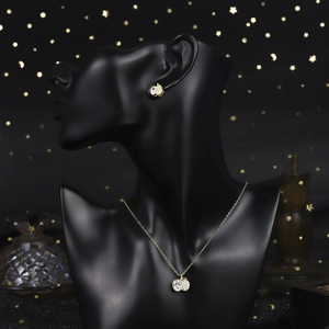 Macro view of vintage style 18K gold plated zircon necklace and earrings set on model