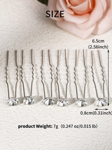 Macro detail of U-shaped bridal hair pins with size labels and clear rhinestone setting
