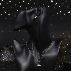 Close-up of vintage style 18K gold plated eight-point star jewelry set with pavé zircons
