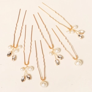 Detail of 6-piece golden U-shaped hair pins with faux pearls and marquise crystals