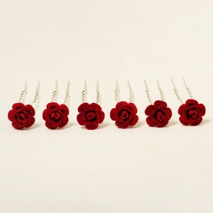Detail view of 6-piece red velvet rose U-shaped hair pins for elegant bridal hairstyling