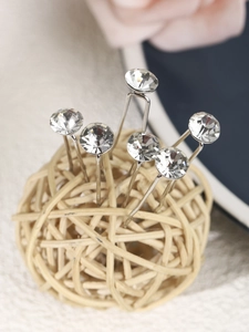 Detailed macro view of bridal rhinestone hair pins with sparkling round cut crystals