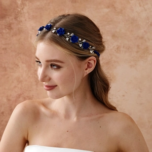 Detail of pink floral hairpiece set with deep blue clay roses and faux pearls