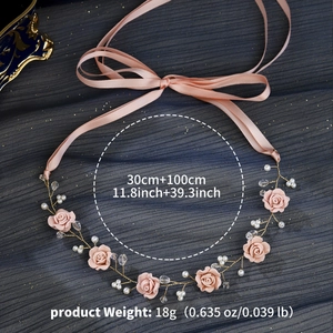 Detail view of handmade pink floral hairpiece with pearls and 30cm length decoration