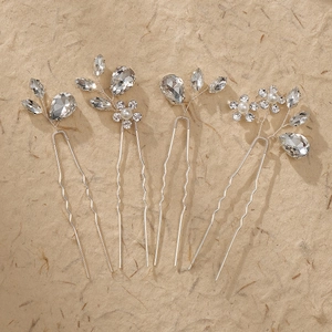Detailed macro view of four-piece silver crystal hair pins with white pearls and beads