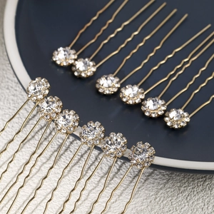 Detailed view of 12-piece golden U-shaped hair pins with sparkling rhinestone clusters