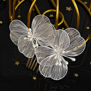 Detailed macro view of white petal hair combs with gold plating and pearl accents