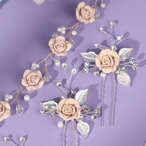 Detailed view of pink floral hair piece set with pearls and crystals for wedding hairstyles