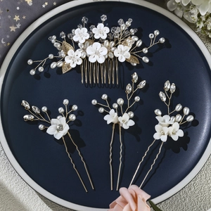 Exquisite bridal hair accessories set with white clay flowers and pearls on gold wire