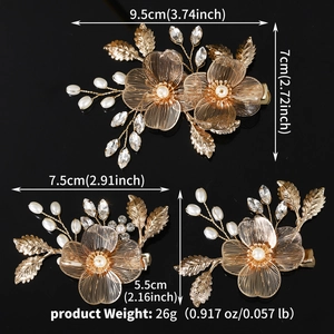 Detailed view of gold leaf hair clips with pearls and rhinestones in two distinct sizes
