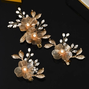 Three-piece gold filigree flower hair clips with pearls and crystals on black reflection