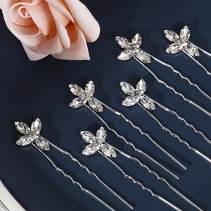 Macro detail of six sparkling rhinestone butterfly hair pins for bridal updo hairstyles